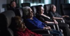 Arcare aged care watching a movie in the theatre room 01
